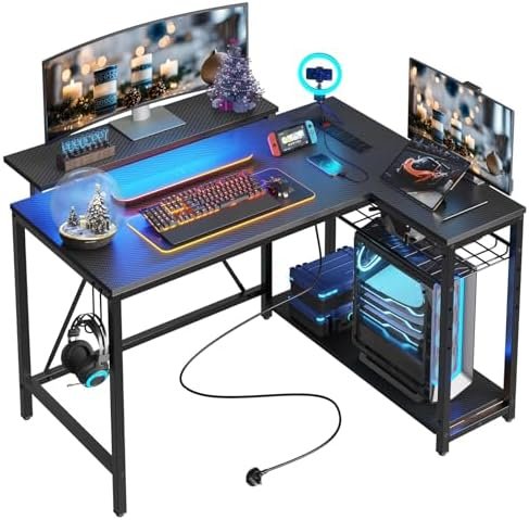 Bestier Small Gaming Desk with Power Outlets,42 L Shaped LED Computer Desk with Stand Reversible Shelves,Corner Gamer Desk with Headset Hooks USB Charging Port,Carbon Fiber Black